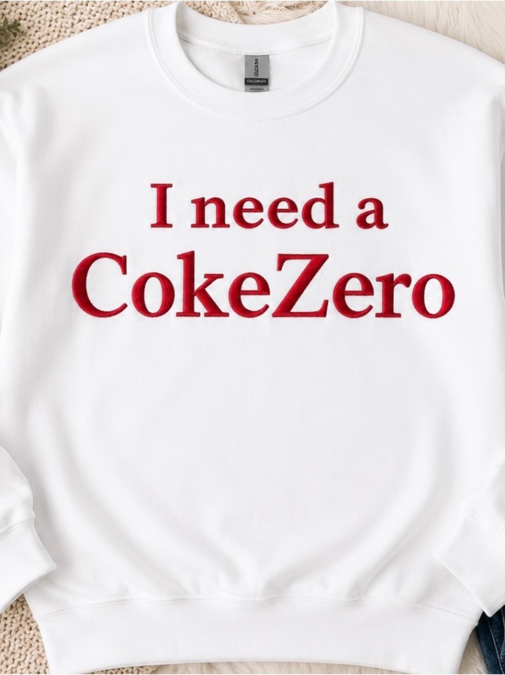 White Crewneck Sweater with Red 'I need a CokeZero' Graphic